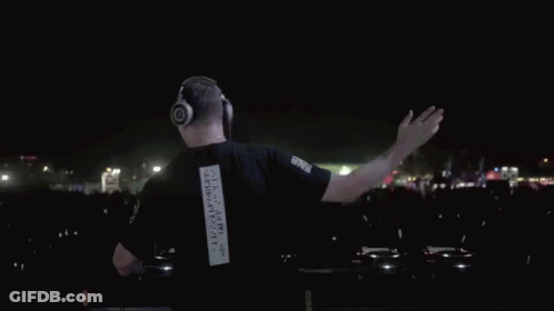 A Man Wearing Headphones And A Black Shirt With The Number 1 On The Back GIF