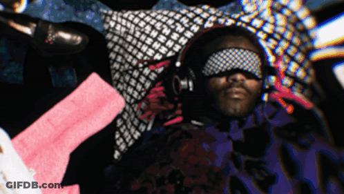 A Man Wearing Headphones And A Blindfold With The Letter N On It GIF