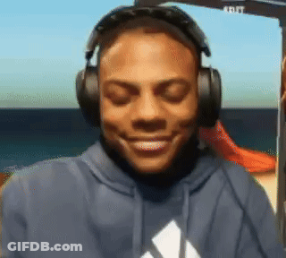 A Man Wearing Headphones And A Blue Adidas Hoodie Smiles GIF