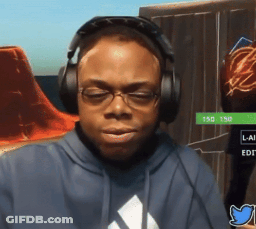 A Man Wearing Headphones And A Blue Adidas Shirt Is Looking Down GIF