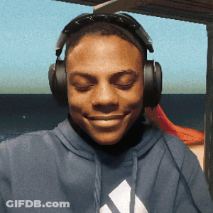 A Man Wearing Headphones And A Blue Adidas Sweatshirt Smiles GIF
