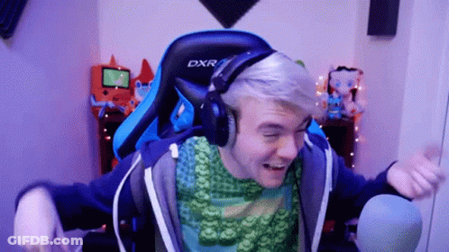A Man Wearing Headphones And A Blue Dxr Chair GIF