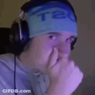 A Man Wearing Headphones And A Blue Headband Is Covering His Nose With His Hand . GIF