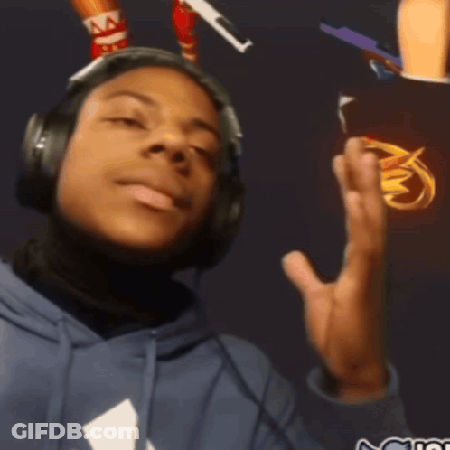A Man Wearing Headphones And A Blue Hoodie With A White Triangle On The Front GIF