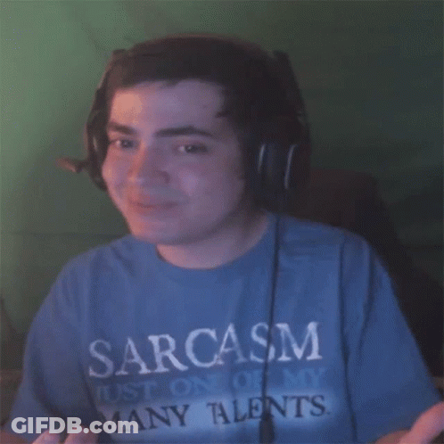 A Man Wearing Headphones And A Blue Shirt That Says Sarcasm On It GIF