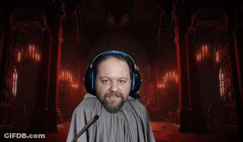 A Man Wearing Headphones And A Cape Holds A Green Wand GIF