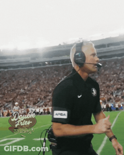 A Man Wearing Headphones And A Double Fries Sign On The Field GIF
