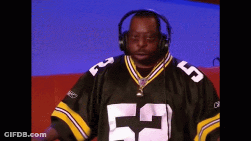 A Man Wearing Headphones And A Green Bay Packers Jersey With The Number 53 On It GIF