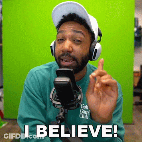 A Man Wearing Headphones And A Green Shirt Says I Believe In Front Of A Green Screen GIF