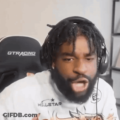 A Man Wearing Headphones And A Gtracing Chair GIF