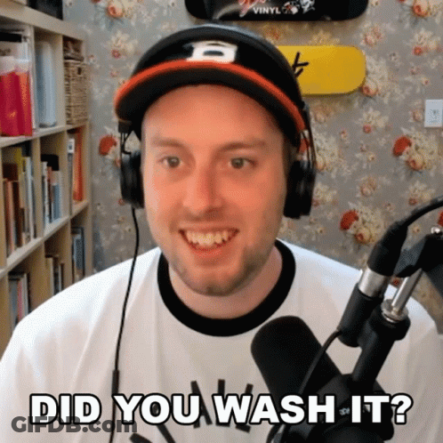A Man Wearing Headphones And A Hat Asks " Did You Wash It " In Front Of A Microphone GIF