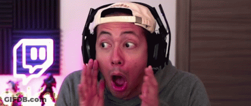 A Man Wearing Headphones And A Hat Is Making A Funny Face . GIF