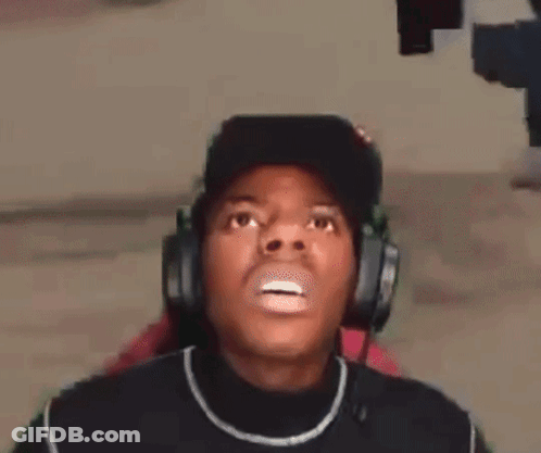 A Man Wearing Headphones And A Hat Is Making A Surprised Face . GIF