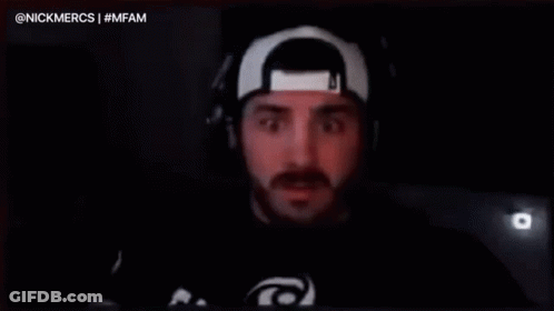 A Man Wearing Headphones And A Hat Is Saying `` I Dunno Fam '' In Front Of A Microphone . GIF