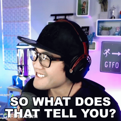 A Man Wearing Headphones And A Hat Is Smiling And Says So What Does That Tell You GIF