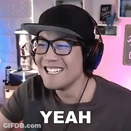 A Man Wearing Headphones And A Hat Is Smiling And Says Yeah GIF
