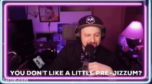 A Man Wearing Headphones And A Hat Is Talking Into A Microphone While Sitting In Front Of A Neon Sign . GIF