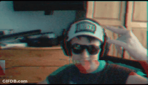 A Man Wearing Headphones And A Hat That Says Miami GIF