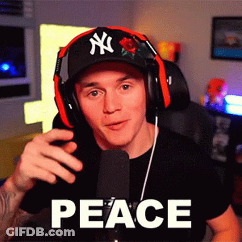 A Man Wearing Headphones And A Hat With Ny On It GIF