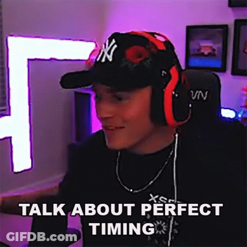 A Man Wearing Headphones And A Hat With Ny On It Says Talk About Perfect Timing GIF