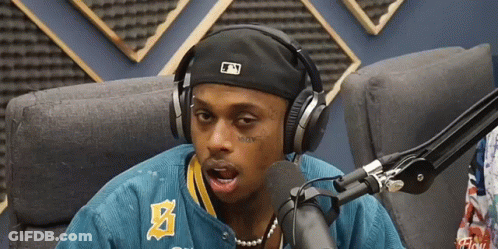 A Man Wearing Headphones And A Hat With The Letter N On It GIF