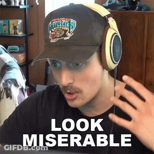 A Man Wearing Headphones And A Hat With The Words Look Miserable GIF
