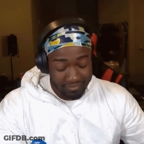 A Man Wearing Headphones And A Headband Is Looking At The Camera GIF