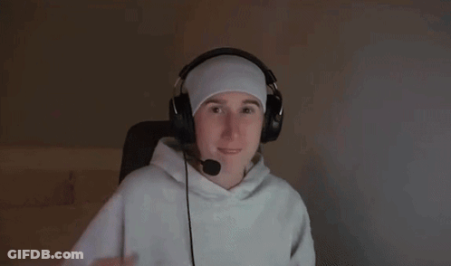 A Man Wearing Headphones And A Headband Is Reaching Out With His Hand GIF