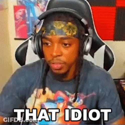 A Man Wearing Headphones And A Headband Is Sitting In A Chair With The Words `` That Idiot '' Written On His Face . GIF