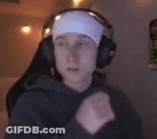 A Man Wearing Headphones And A Headband Is Sitting In Front Of A Computer . GIF