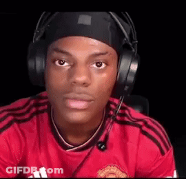 A Man Wearing Headphones And A Headband Is Sitting In Front Of A Computer Screen . GIF