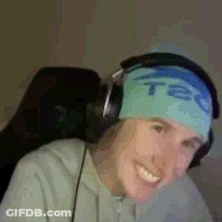 A Man Wearing Headphones And A Headband That Says Tec Is Smiling . GIF