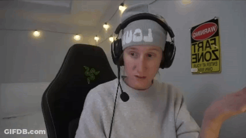 A Man Wearing Headphones And A Headband With The Letter J On It Sits In A Chair GIF