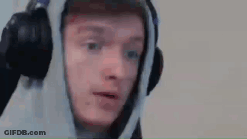 A Man Wearing Headphones And A Hoodie Is Saying Sorry . GIF