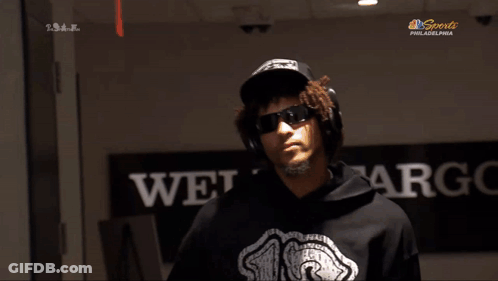 A Man Wearing Headphones And A Hoodie With The Number 18 On It GIF