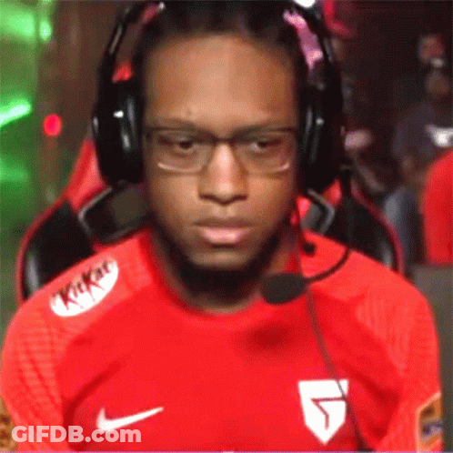 A Man Wearing Headphones And A Kitkat Shirt Is Sitting In A Chair GIF