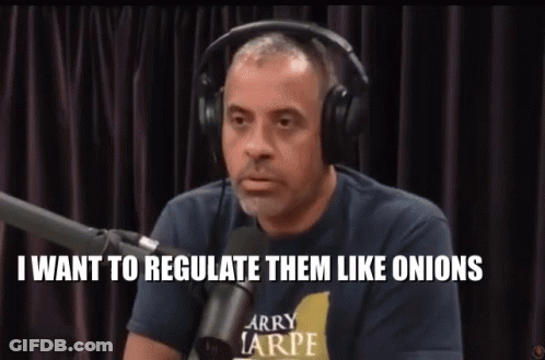 A Man Wearing Headphones And A Larry Tarpe Shirt Is Talking Into A Microphone GIF