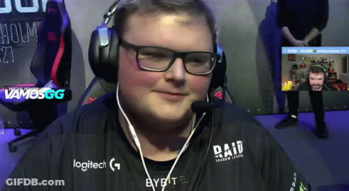A Man Wearing Headphones And A Logitech Shirt Is Smiling GIF