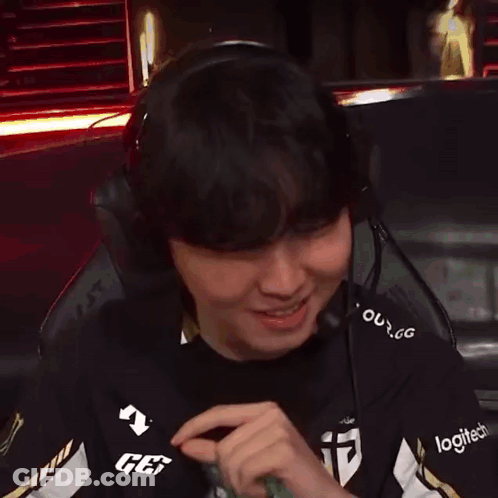 A Man Wearing Headphones And A Logitech Shirt Is Smiling GIF