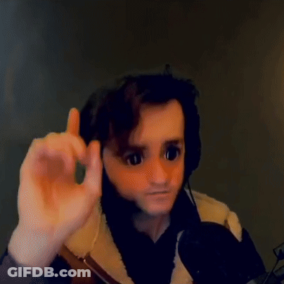 A Man Wearing Headphones And A Mask Is Giving A Thumbs Up Sign While Sitting In Front Of A Microphone . GIF