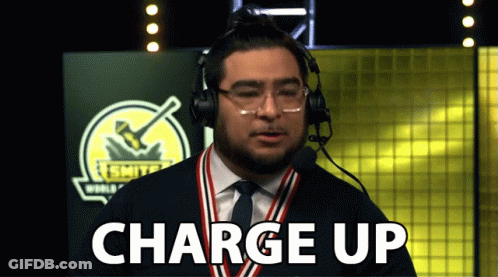 A Man Wearing Headphones And A Medal Around His Neck Is Saying Charge Up GIF