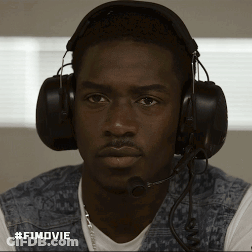 A Man Wearing Headphones And A Microphone Has #Fimovie Written On The Bottom Right GIF