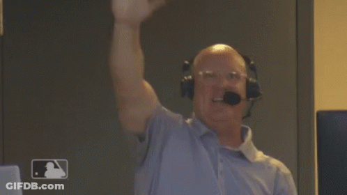 A Man Wearing Headphones And A Microphone Holds His Fist In The Air . GIF