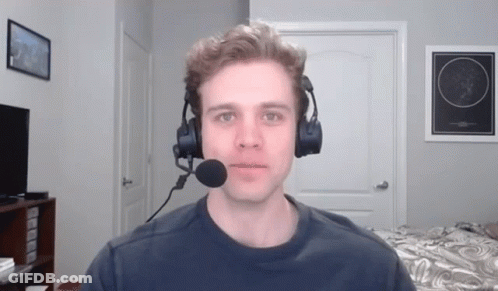 A Man Wearing Headphones And A Microphone In A Room GIF