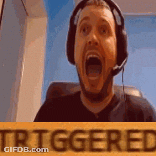 A Man Wearing Headphones And A Microphone Is Holding A Sign That Says Triggered GIF
