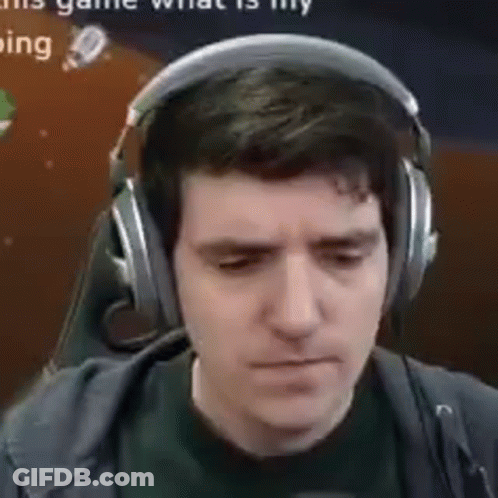 A Man Wearing Headphones And A Microphone Is Looking Down . GIF