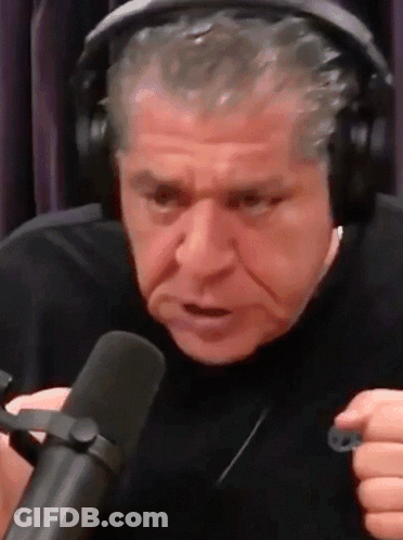 A Man Wearing Headphones And A Microphone Is Making A Funny Face . GIF