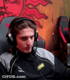 A Man Wearing Headphones And A Microphone Is Sitting In A Chair In Front Of A Computer . GIF