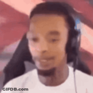 A Man Wearing Headphones And A Microphone Is Sitting In Front Of A Computer Screen . GIF