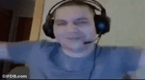 A Man Wearing Headphones And A Microphone Is Sitting In Front Of A Computer . GIF